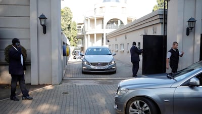 Police at the gate to the compound of the Guptas' property in Johannesburg. AFP