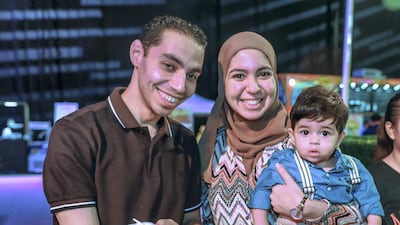 Nayera and Mohammad Ramadan with son Yahya enjoy the Ramadan exhibition. Victor Besa / The National