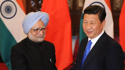 Mr Singh with China's President Xi Jinping before a meeting in Beijing, in 2013. Getty Images