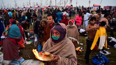 A devotee performs the 'Ganga Arti' ritual after taking a holy dip at the annual Hindu festival at Sangam, the confluence of the rivers Ganges, Yamuna and the mythical Saraswati, in Allahabad. AFP