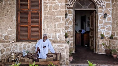 A man rests outside the hotel's arched stone entrance. Photo: El Quseir Hotel