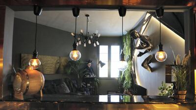 DUBAI , UNITED ARAB EMIRATES , December 15 – 2018 :- View of the kitchen and drawing room at the apartment of Areeb Hassan in International City in Dubai. ( Pawan Singh / The National ) For Luxury and Lifestyle. Story by Melanie Hunt