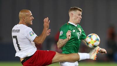 Republic of Ireland's James McClean, right, battles for possession with Jaba Kankava of Georgia. Reuters