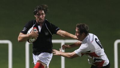 UAE player Adam Telford avoids a tackle during a test match between UAE and Singapore at The Sevens in Dubai, April 23, 2014. (Sarah Dea/TheNational)