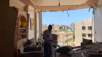 Abu Alkas looks at the damage to his home caused by Israeli airstrikes in Gaza. Nagham Mohanna for The National