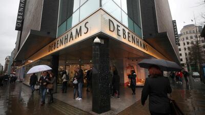 Shoppers walk past Debenhams on Oxford Street in central London. Reuters