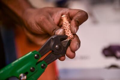 Gold grains being weighed before the melting process. Khushnum Bhandari / The National