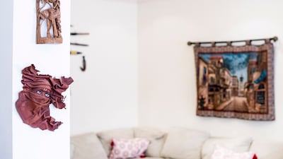 Souvenirs include masks from Madagascar and Nepal, and frames from the Philippines and Thailand.