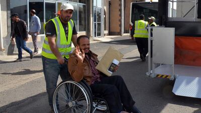 An airport worker pushes a sick Yemeni in a wheelchair before boarding a UN medical evacuation plane at Sana'a airport, Yemen. EPA