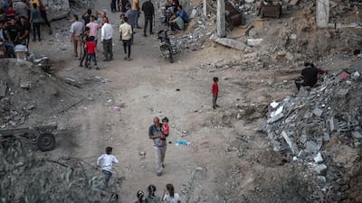 Palestinians walk around Beit Hanoun, northern Gaza, on May 22, 2021. Getty