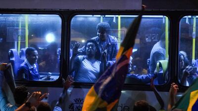 Supporters of Jair Bolsonaro celebrate in a bus in front of his house in Rio de Janeiro. AP Photo