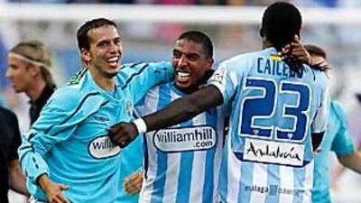 Malaga players celebrate avoiding relegation last season.