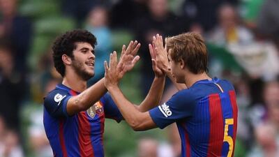 Barcelona’s Carles Alena and Sergi Samper celebrate at the end of the International Champions Cup football match between Barcelona and Celtic at the Aviva Stadium in Dublin on July 30, 2016. Clodagh Kilcoyne / Reuters