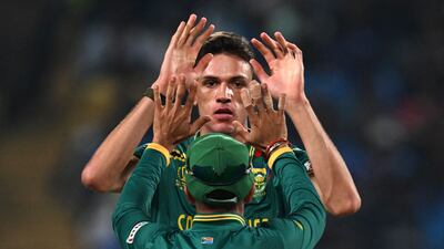 South Africa's Marco Jansen celebrates with teammate Keshav Maharaj after taking the wicket of New Zealand's Devon Conway. AFP
