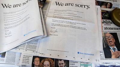 July 16, 2011: Newspapers are opened to show the advertisement apology for News International in central London. News Corporation chairman Rupert Murdoch signed the company advert entitled "We are sorry", which appeared in British national newspapers Sa???