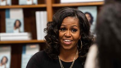 Former US First Lady Michelle Obama meets with fans during a book signing on the first anniversary of the launch of her memoir 'Becoming' at the Politics and Prose bookstore in Washington, DC, on November 18, 2019. AFP