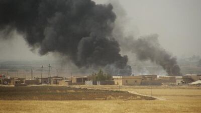 Smoke rises in the oil-rich city of Kirkuk, Iraq. The country has been affected by the oil price slump as well as the insurgency of the Islamic State. AP Photo