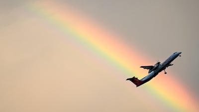 A SpiceJet aircraft flies past a rainbow in Chennai, India. AFP