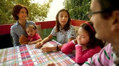 Caroline Tenneson with her daughters and husband at their home in Abu Dhabi.