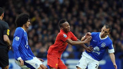 Liverpool's Raheem Sterling in action against Everton's Leon Osman and Marouane Fellaini at Goodison Park. Peter Powell/EPA