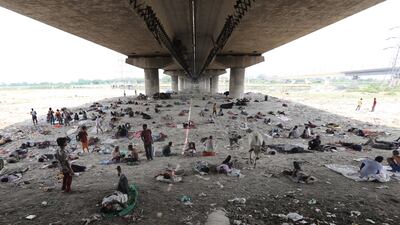 People shelter under a bridge from scorching heat in New Delhi. EPA