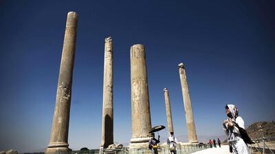 A Chinese tourist from Hong Kong looks at the coloumns of the ancient Persian city of Persepolis near Shiraz in southern Iran. Persepolis, a jewel of the first Persian empire whose palace and terraces took more than 100 years to build, starting under Darius the Great in 518 BC, is one of the country's highlights. Behrouz Mehri/ AFP