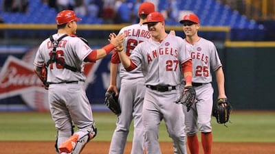 Outfielder Mike Trout, No 27, of the Angels, celebrates their 6-5 win against the Rays with catcher Hank Conger, No 16, late on Tuesday. Al Messerschmidt / Getty Images / AFP