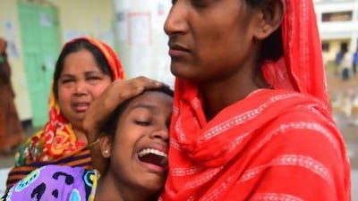 A Bangladeshi woman identifies the body of her father killed in last week's building collapse in Savar, on the outskirts of Dhaka.