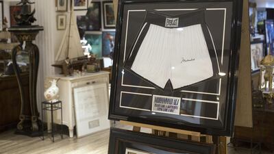 Above, a boxing trunks signed by Mohammed Ali on display at Ocean View Antiques and Antiquities shop in Dubai. Clint McLean for The National