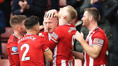 Sheffield United's John Lundstram, centre, is mobbed by teammates after his winning goal against Bournemouth. PA