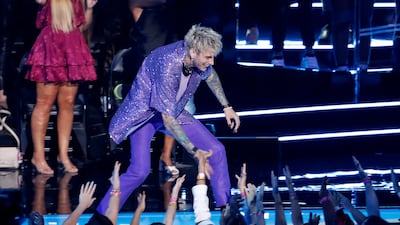 Machine Gun Kelly celebrates with the audience after winning the award for Best Alternative for 'My Ex's Best Friend'. Reuters