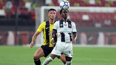 Al Jazira's Felicio Milson controls the ball under pressure from Al Ittihad's Jan-Carlo Simic.