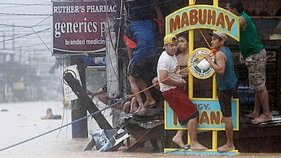 Stranded Filipinos cling on to signs above their buildings in Marikina City, Metro Manila.