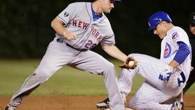Daniel Murphy of the New York Mets fails to make the tag on the Cubs' Anthony Rizzo.