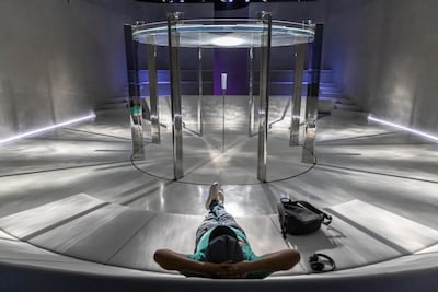 The meditation room has comfortable seats arranged around a projector, beaming water ripples and waves on the ceiling. Antonie Robertson / The National