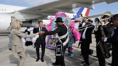 Mr Macron and the French first lady cut a rug on the tarmac in New Orleans. AFP