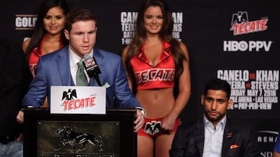 Saul Alvarez speaks as Amir Khan looks on during their final press conference. John Gurzinski / AFP