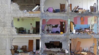 Palestinian Mousa Sweidan, 50, walks in one of the rooms of his father’s damaged home in the Sha’af neighbourhood of Gaza City. The family of 15 people fled from their home when Israeli tanks entered the neighbourhood and they took shelter in a UN school. Mousa used to work in Israel as a painter until 2005 and is now unemployed. Negotiators in Cairo were trying to end the month long war between Hamas and Israel.