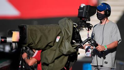 A cameraman wears a protective face mask. EPA