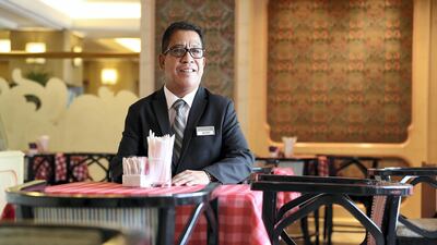 Buddy, the popular and long-standing supervisor of Beaujolais restaurant in Abu Dhabi, has clocked up 25 years at the popular eatery. Pawan Singh / The National