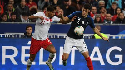 Turkey's midfielder Irfan Kahveci, left, vies for the ball with France's defender Benjamin Pavard. AFP