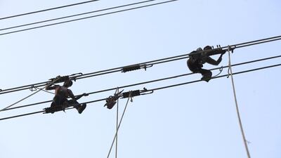 Men work to build electric transmission lines in India. Adeel Halim / Bloomberg