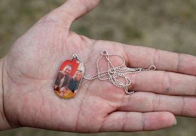 Aya Al Umari shows a pendant with a photo of her with her brother Hussein, who was killed in the shooting at Al Noor mosque in Christchurch on March 15, 2019. AP Photo