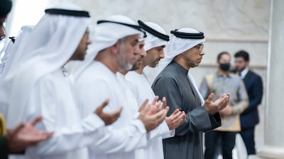 Sheikh Mansour bin Zayed and Sheikh Hamdan bin Mohamed pray during the inauguration of the Sheikh Zayed Grand Mosque.