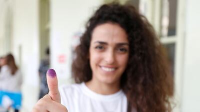 A woman shows her ink-stained finger after casting her vote during the parliamentary election in Beirut, Lebanon. Jamal Saidi / Reuters