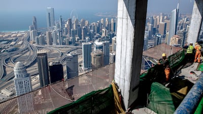 The view over Dubai Marina from the under-construction Uptown Tower. Experts predict the city will see a housing boom as more residential towers and villas are needed. Victor Besa / The National