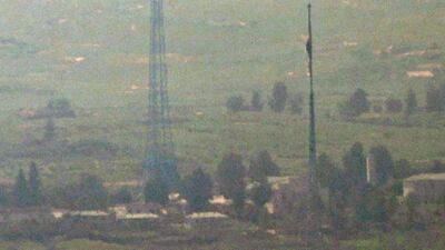 The flags of South and North Korea fly in the South's Daeseong Village, bottom, and the North's Kijong Village, top, in this photo taken from an observatory in the South Korean border city of Paju on July 27, 2021. The two Koreas reopened direct cross-border communication lines that Pyongyang severed last year.