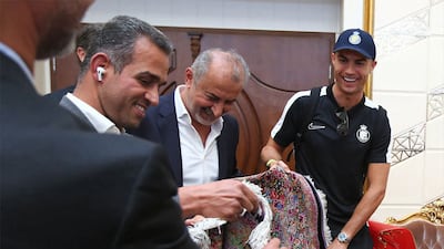 Cristiano Ronaldo, right, is delighted to receive a Persian rug as a gift. EPA