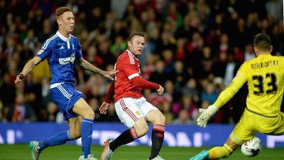 Manchester United's Wayne Rooney scores their opening goal against Ipswich Town on Wednesday night in the League Cup. Gareth Copley / Getty Images