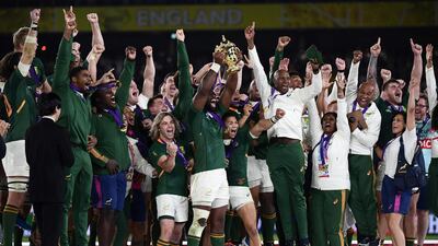 South Africa's flanker Siya Kolisi (C) lifts the Webb Ellis Cup as they celebrate winning the Japan 2019 Rugby World Cup final match between England and South Africa at the International Stadium Yokohama in Yokohama. AFP